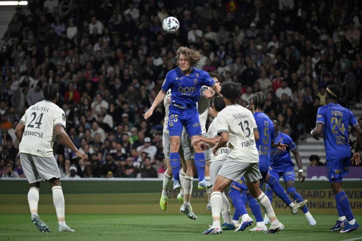 Monaco's Belgian defender #25 Wout Faes (C) heads the ball during the French L1 football match between Toulouse FC and AS Monaco at the TFC Stadium in Toulouse, southwestern France, on April 25, 2026.  Ed JONES / AFP
