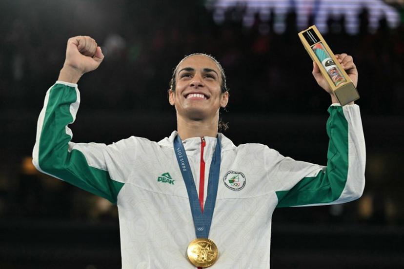 Gold medallist Algeria's Imane Khelif poses on the podium during the medal ceremony for the women's 66kg final boxing category during the Paris 2024 Olympic Games at the Roland-Garros Stadium, in Paris on August 9, 2024.  MOHD RASFAN / AFP