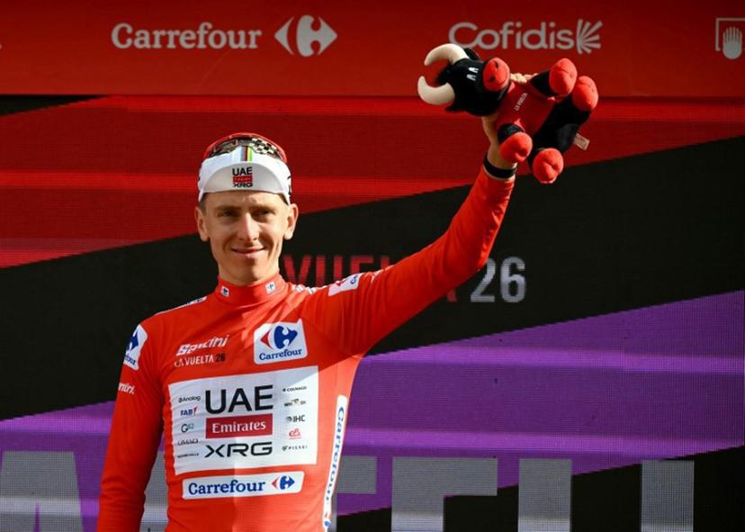 Team UAE's Slovenian rider Tadej Pogacar wearing the overall leader red jersey celebrates on the podium the sixth stage of the Vuelta a Espana 2026, a 177,4 km race between Alcossebre and Castellon de la Plana on August 27, 2026.    JOSE JORDAN / AFP
