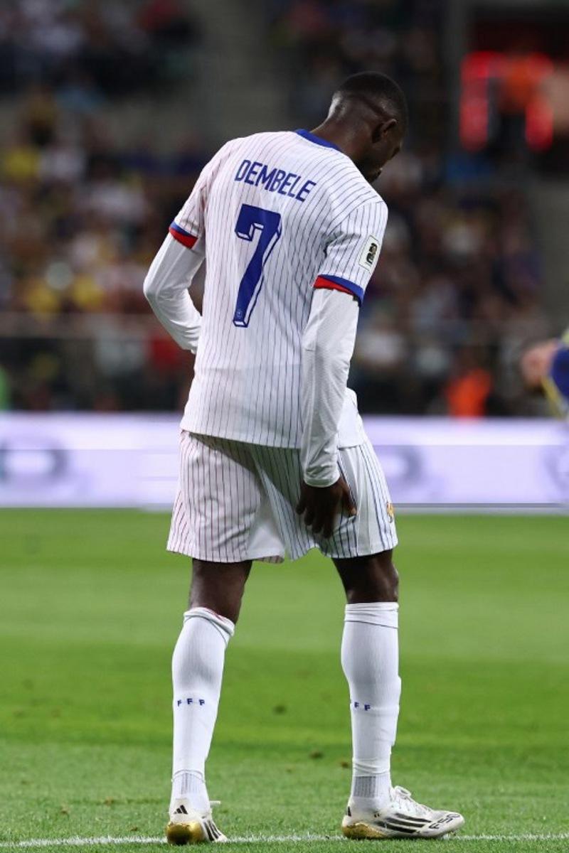 (FILES) France's forward #07 Ousmane Dembele reacts after injury during the 2026 World Cup qualifiers Europe zone group D football match between Ukraine and France, on September 5, 2025 in Wroclaw, Poland. The forward of the French national team and Paris Saint-Germain, Ousmane Dembélé, will be out "six to eight weeks" due to a muscle injury in his right thigh, AFP learned on September 6, 2025, from a source close to the player. FRANCK FIFE / AFP