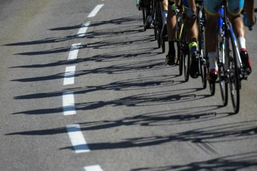 Shadows of wheels are pictured during the 186,5 km eighteenth stage of the 102nd edition of the Tour de France cycling race on July 23, 2015, between Gap and Saint-Jean-de-Maurienne, French Alps.  AFP PHOTO / LIONEL BONAVENTURE