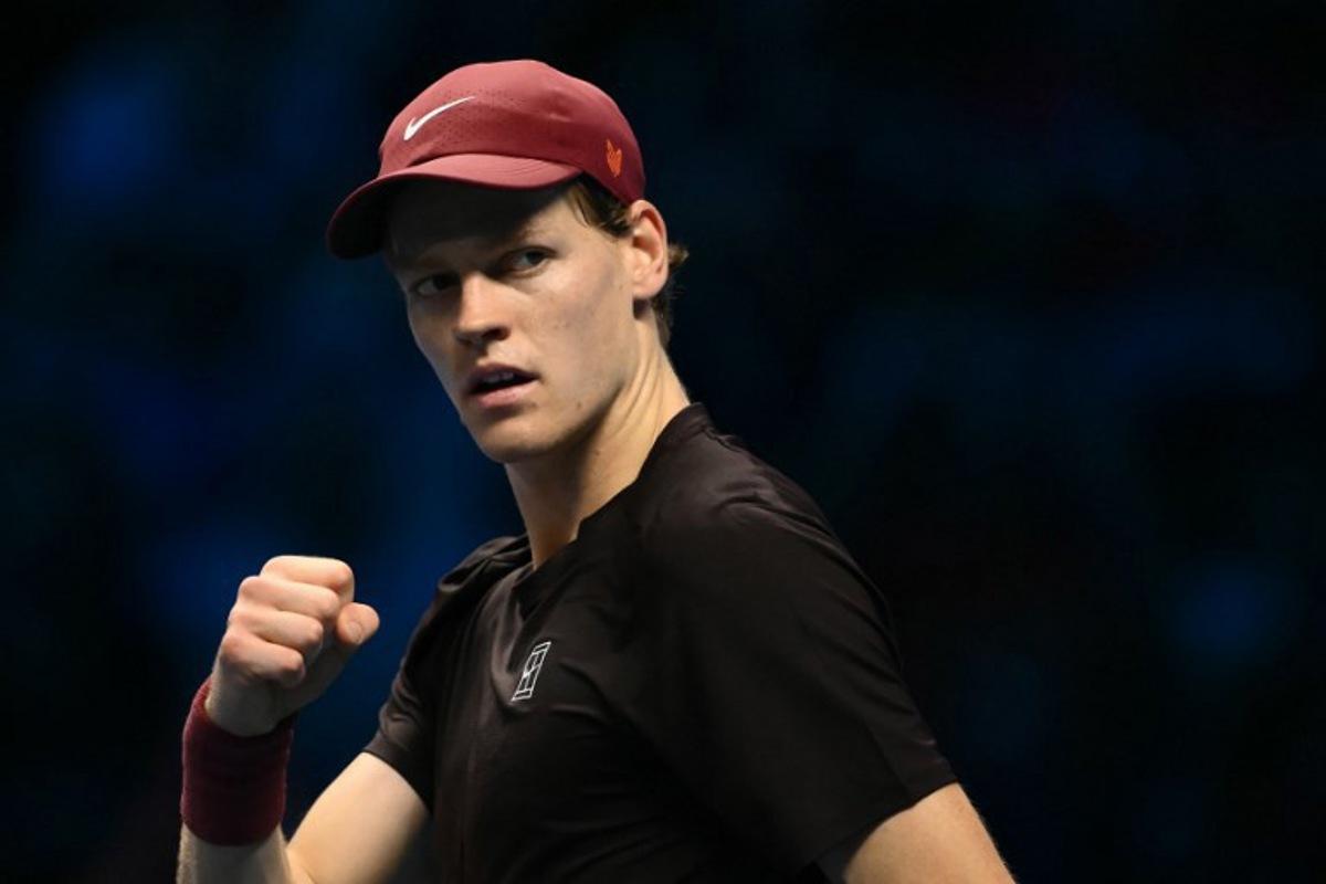 Italy's Jannik Sinner celebrates after winning the first set against Australia's Alex De Minaur at the ATP Finals tennis tournament in Turin on November 15, 2025.  Marco BERTORELLO / AFP