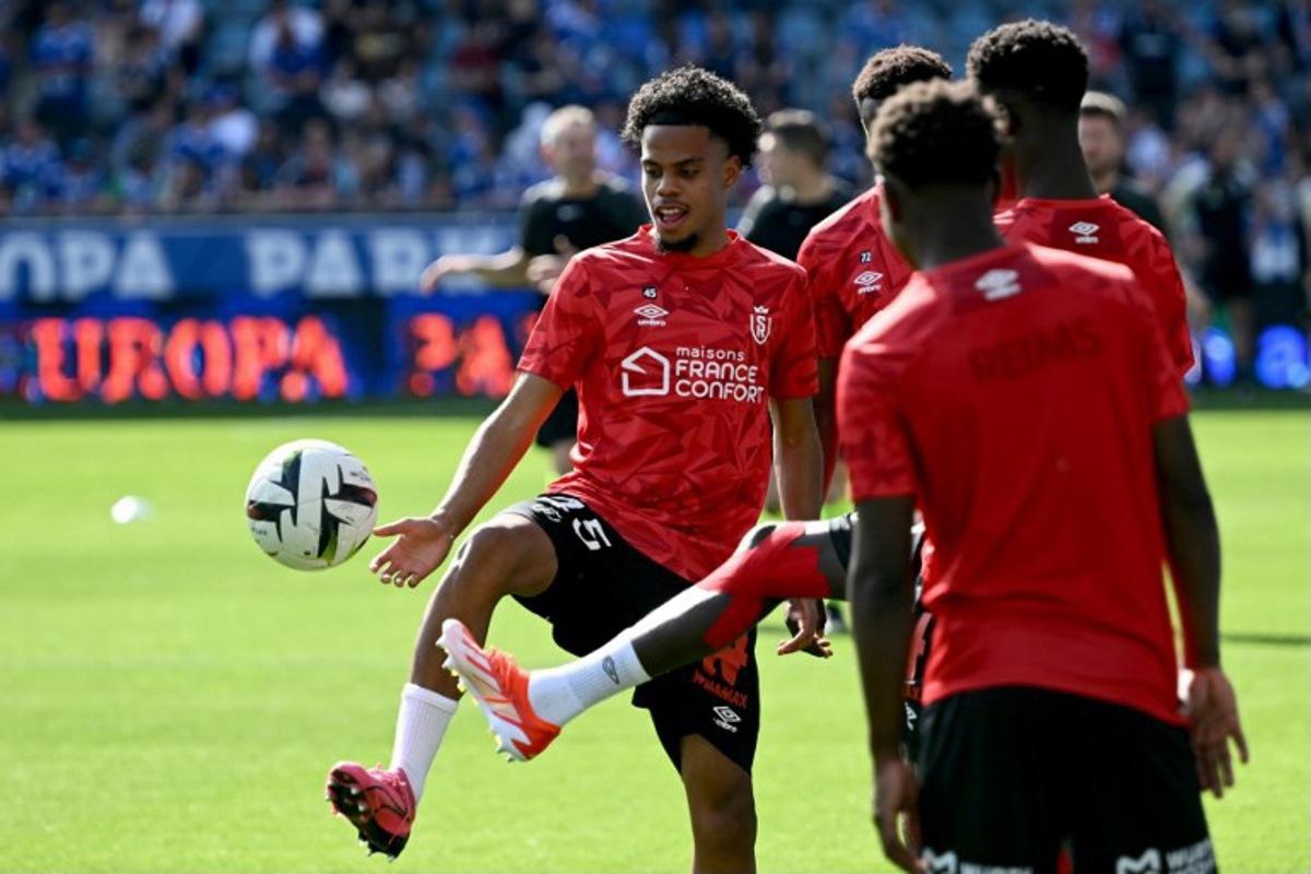 Reims' French defender #45 Therence Koudou (L) warms up prior to the French L1 football match between RC Strasbourg and Stade de Reims at the Stade de la Meinau, in Strasbourg, eastern France, on April 13, 2024.  SEBASTIEN BOZON / AFP