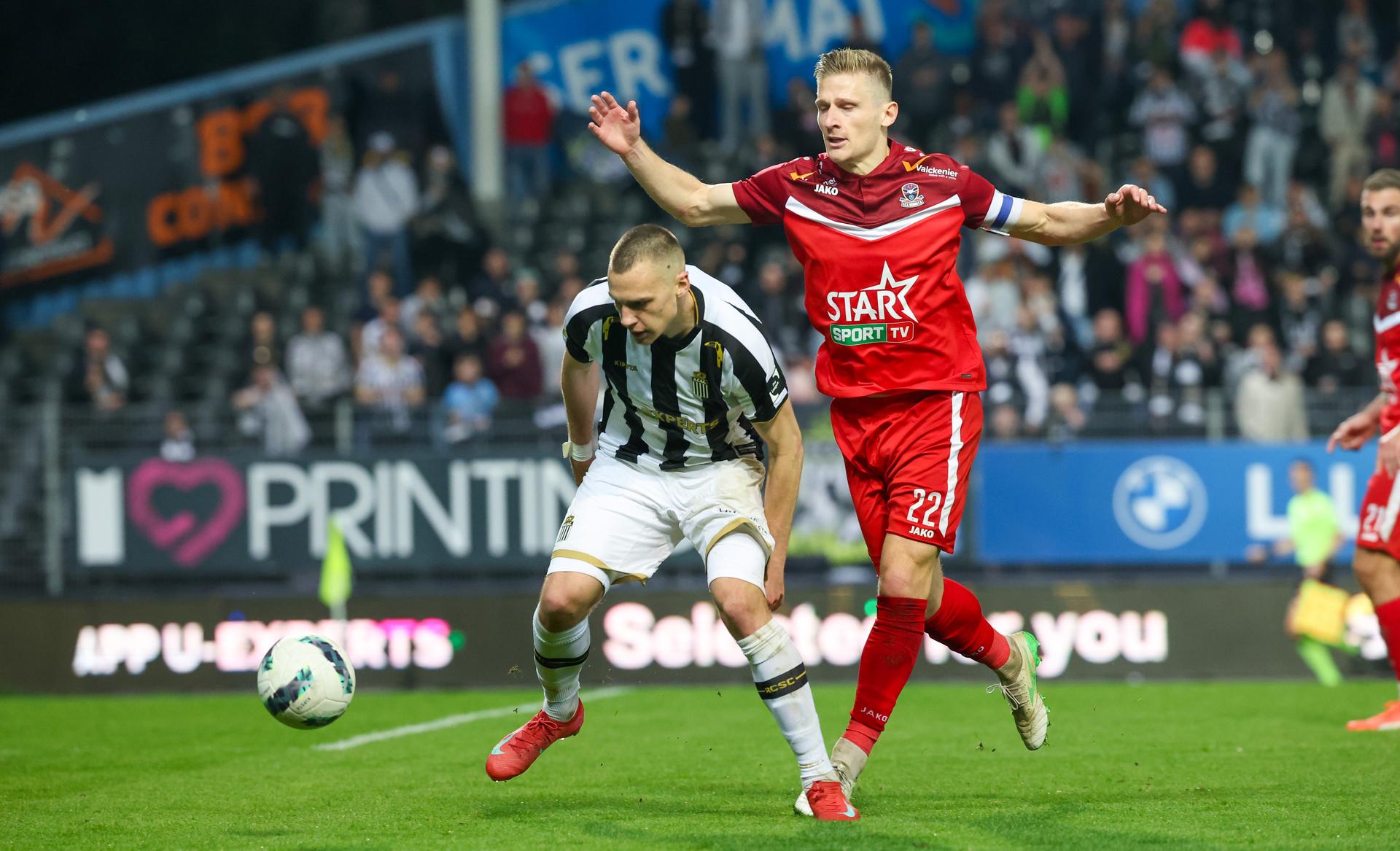 Charleroi's Nikola Stulic and Dender's Gilles Ruyssen fight for the ball during a soccer match between Sporting Charleroi and FCV Dender EH, Saturday 26 April 2025 in Charleroi, on day 6 (out of 10) of the Europe Play-offs of the 2024-2025 'Jupiler Pro League' first division of the Belgian championship. BELGA PHOTO VIRGINIE LEFOUR