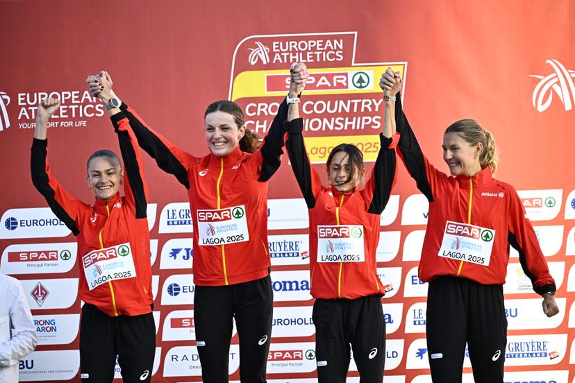 Belgians Jana van Lent, Lisa Rooms, Chloe Herbiet and Victoria Warpy celebrate on the podium after winning the Women Elite race at the 2025 SPAR European Cross Country Championships, in Lagoa, Portugal, Sunday 14 December 2025. BELGA PHOTO JASPER JACOBS