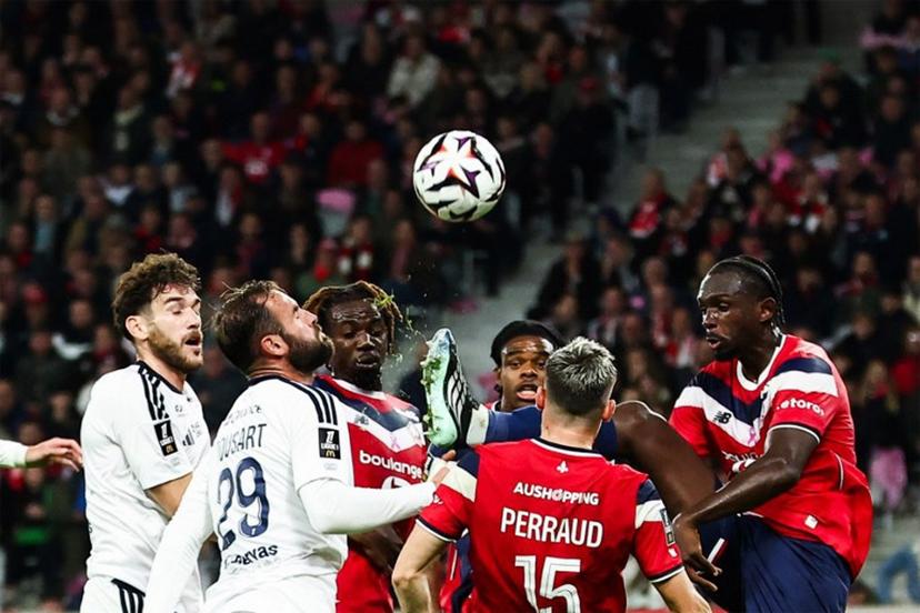 Lille's French defender #23 Tanguy Nianzou (R) shoots the ball during the French L1 football match between Lille LOSC and Stade Brestois 29 (Brest) at the Stade Pierre-Mauroy in Villeneuve-d'Ascq, northern France, on October 17, 2026.  Sameer AL-DOUMY / AFP