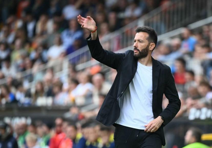 Valencia's Spanish coach Carlos Corberan gestures on the touchline during the Spanish league football match between Valencia CF and Club Atletico de Madrid at Mestalla Stadium in Valencia on May 2, 2026.  JOSE JORDAN / AFP