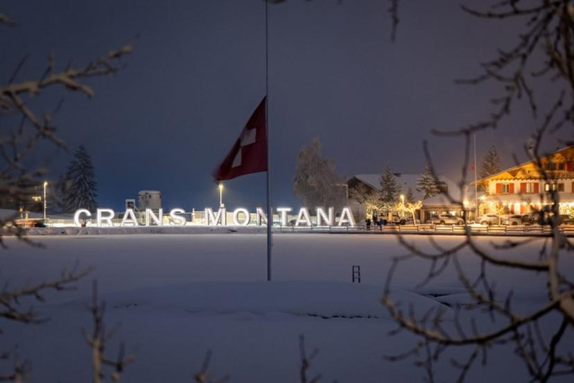 Attendees gather in mourning, placing messages, candles, and flowers at a memorial site in front of the bar "Le Constellation" during a national day of mourning in Crans-Montana, on January 9, 2026, in tribute to the victims of the fire that ravaged the bar on New Year's Eve, killing 40 people and injuring 116 others, most of them teenagers. All of Switzerland will mark a national day of mourning on January 9 for the dozens of mostly teenagers killed when fire ravaged a ski resort bar crammed with New Year revellers. Just over a week after the tragedy at the Le Constellation bar in Crans-Montana, which left 40 dead and 116 injured, the wealthy Alpine nation will come to a standstill for a minute of silence at 2:00 pm (1300 GMT). MAXIME SCHMID / AFP
