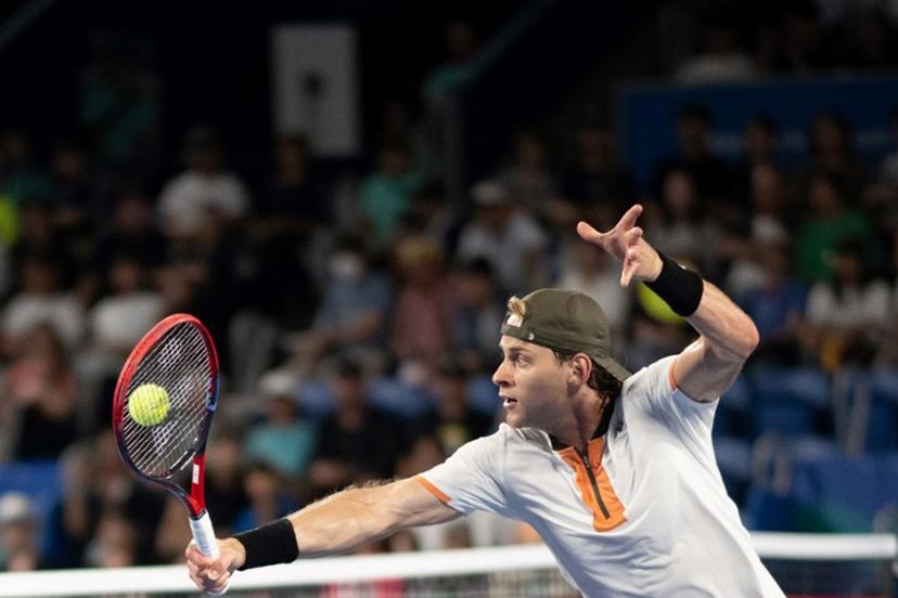 Belgium's Zizou Bergs hits a return against Spain's Carlos Alcaraz during their men's singles match at the ATP Japan Open tennis tournament in Tokyo on September 27, 2025.  Philip FONG / AFP