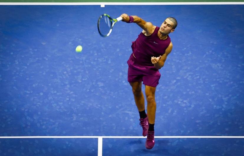 Spain's Carlos Alcaraz serves to USA's Reilly Opelka during their men's singles first round tennis match on day two of the US Open tennis tournament at the USTA Billie Jean King National Tennis Center in New York City, on August 25, 2025.  Kena Betancur / AFP