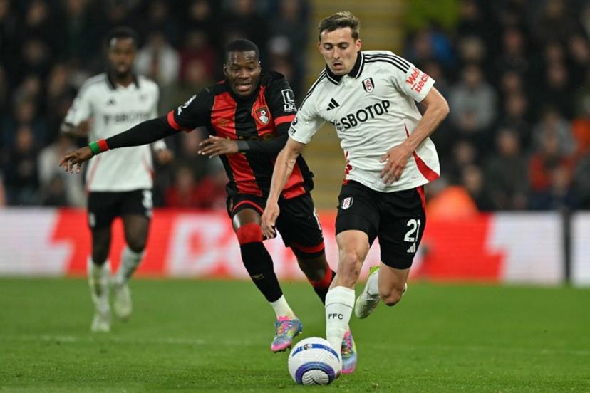 Fulham's Belgian defender #21 Timothy Castagne (R) runs away from Bournemouth's Burkinabe striker #11 Dango Ouattara (L) during the English Premier League football match between Bournemouth and Fulham at the Vitality Stadium in Bournemouth, southern England on April 14, 2025.  Glyn KIRK / AFP