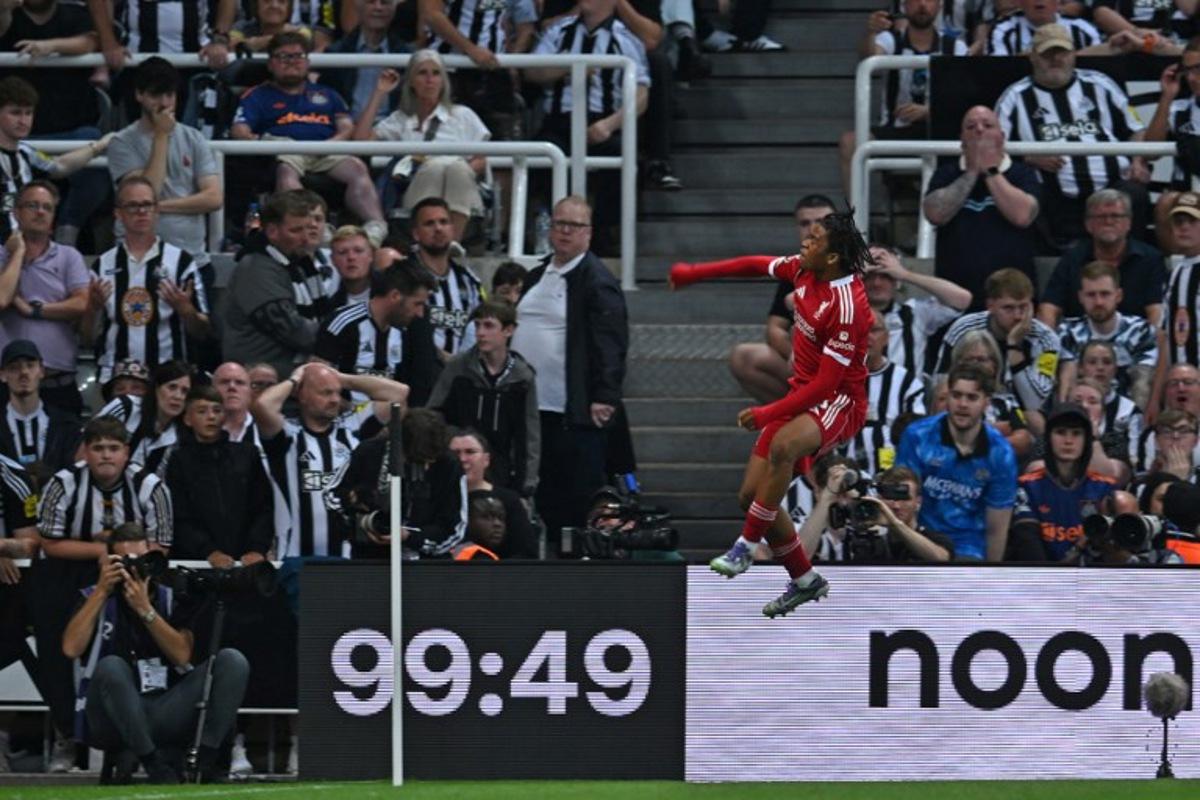 Liverpool's English striker #73 Rio Ngumoha celebrates in front of the Newcastle fans after scoring their third goal during the English Premier League football match between Newcastle United and Liverpool at St James' Park in Newcastle-upon-Tyne, north east England on August 25, 2025.  ANDY BUCHANAN / AFP