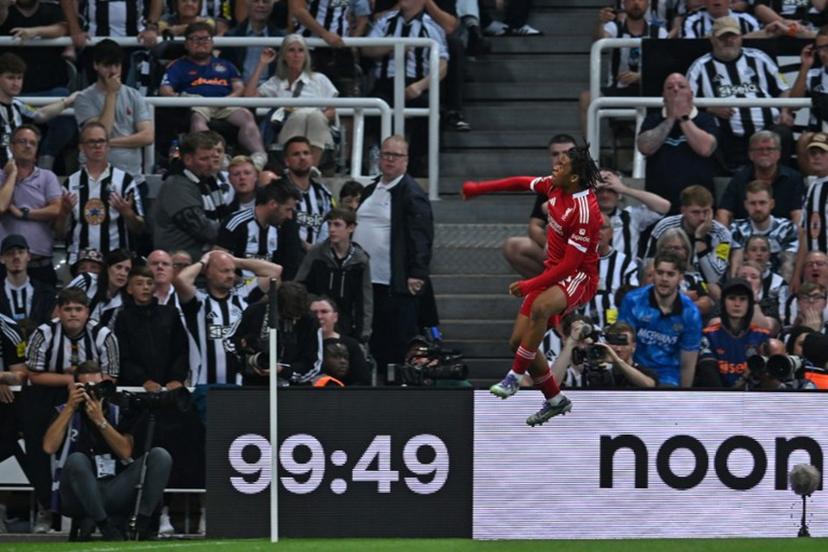 Liverpool's English striker #73 Rio Ngumoha celebrates in front of the Newcastle fans after scoring their third goal during the English Premier League football match between Newcastle United and Liverpool at St James' Park in Newcastle-upon-Tyne, north east England on August 25, 2025.  ANDY BUCHANAN / AFP