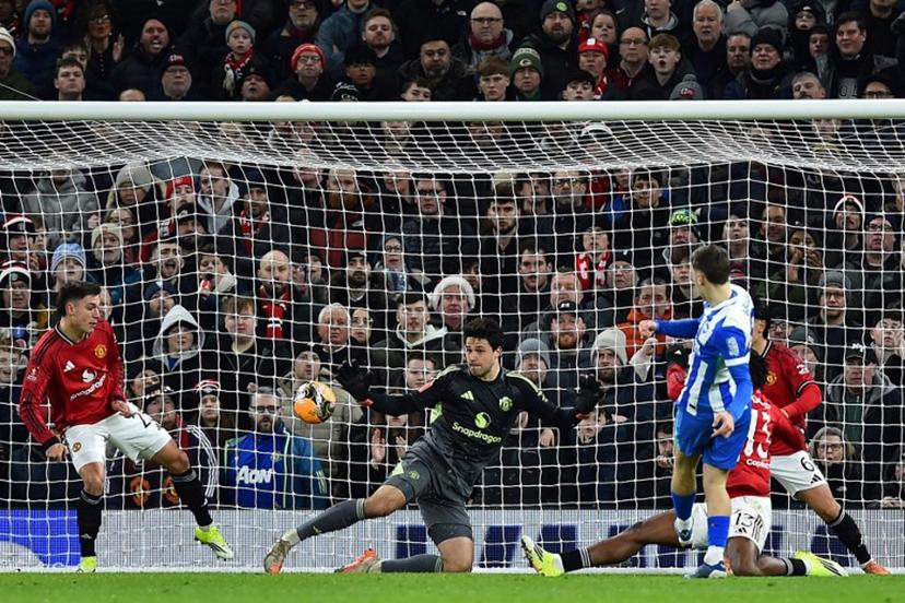 Brighton's German midfielder #08 Brajan Gruda (R) scores the opening goal during the English FA Cup third round football match between Manchester United and Brighton and Hove Albion at Old Trafford Stadium in Manchester, north west England, on January 11, 2026.  PETER POWELL / AFP