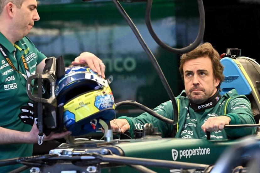 Aston Martin's Spanish driver Fernando Alonso inspects his car with team mechanics in the garage ahead of the Formula One Australian Grand Prix at Melbourne's Albert Park on March 5, 2026.  Paul Crock / AFP