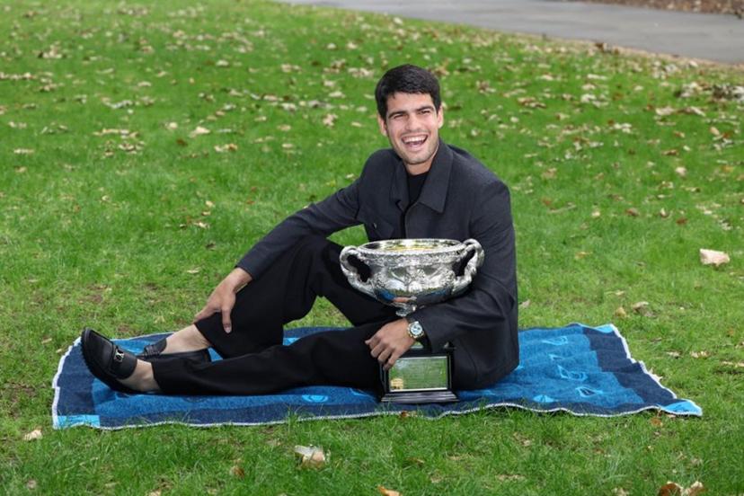 Spain's Carlos Alcaraz poses with the Norman Brookes Challenge Cup at the Royal Exhibition Building following his victory against Serbia's Novak Djokovic in the men's singles final match of the Australian Open tennis tournament in Melbourne on February 2, 2026.  David GRAY / AFP