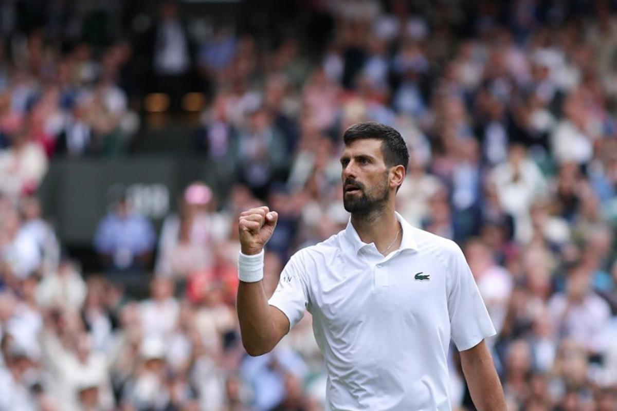 Serbia's Novak Djokovic reacts as he plays against Australia's Alex De Minaur during their men's singles fourth round tennis match on the eighth day of the 2025 Wimbledon Championships at The All England Lawn Tennis and Croquet Club in Wimbledon, southwest London, on July 7, 2025.  Adrian Dennis / AFP