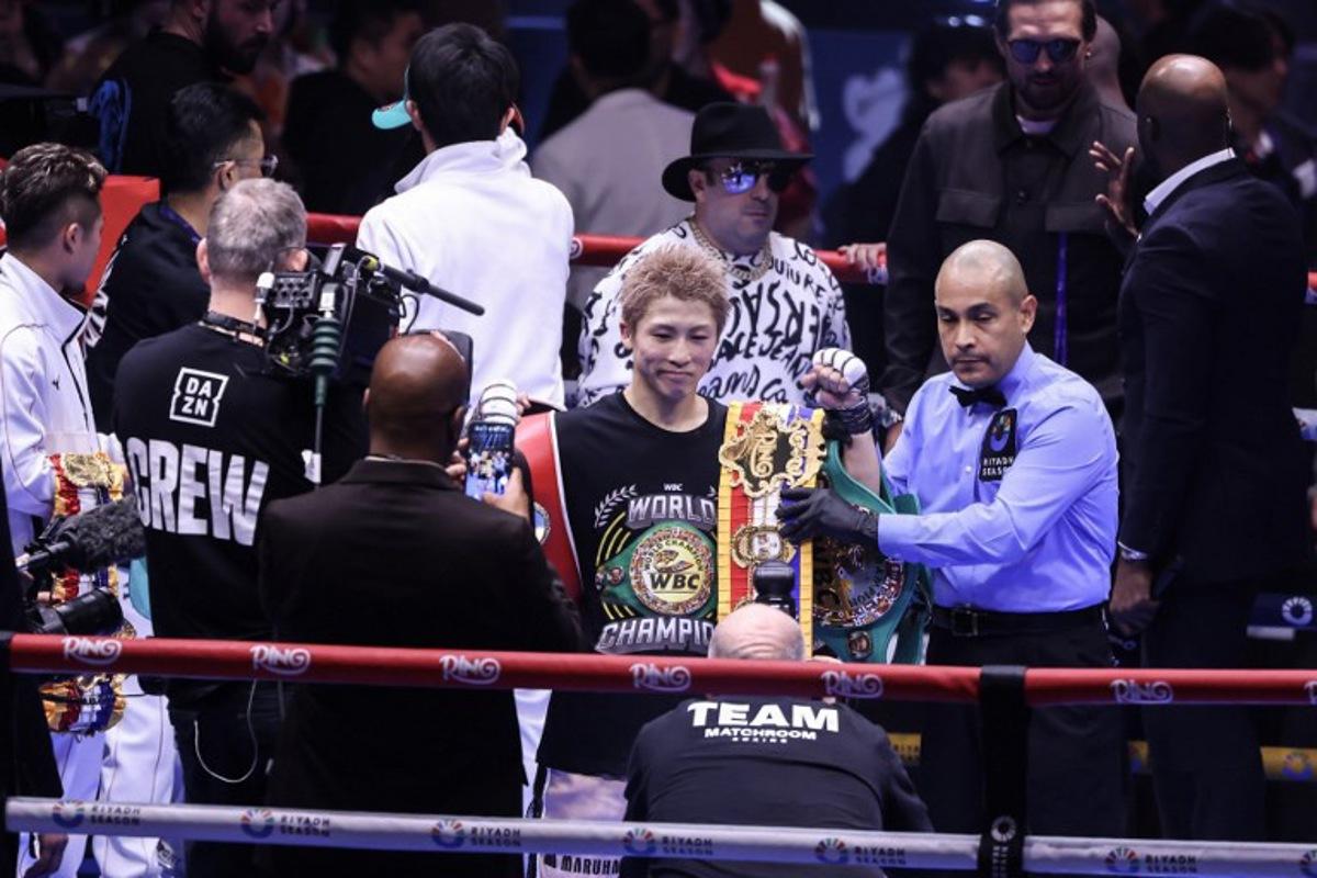 Japan's boxer Naoya Inoue celebrates with the winner's belt after beating Mexico's boxer David Picasso in the "The Ring V night of Samurai" final major fight card of the year at the Mohammed Abdo Arena in Riyadh on December 27, 2025.  Fayez NURELDINE / AFP