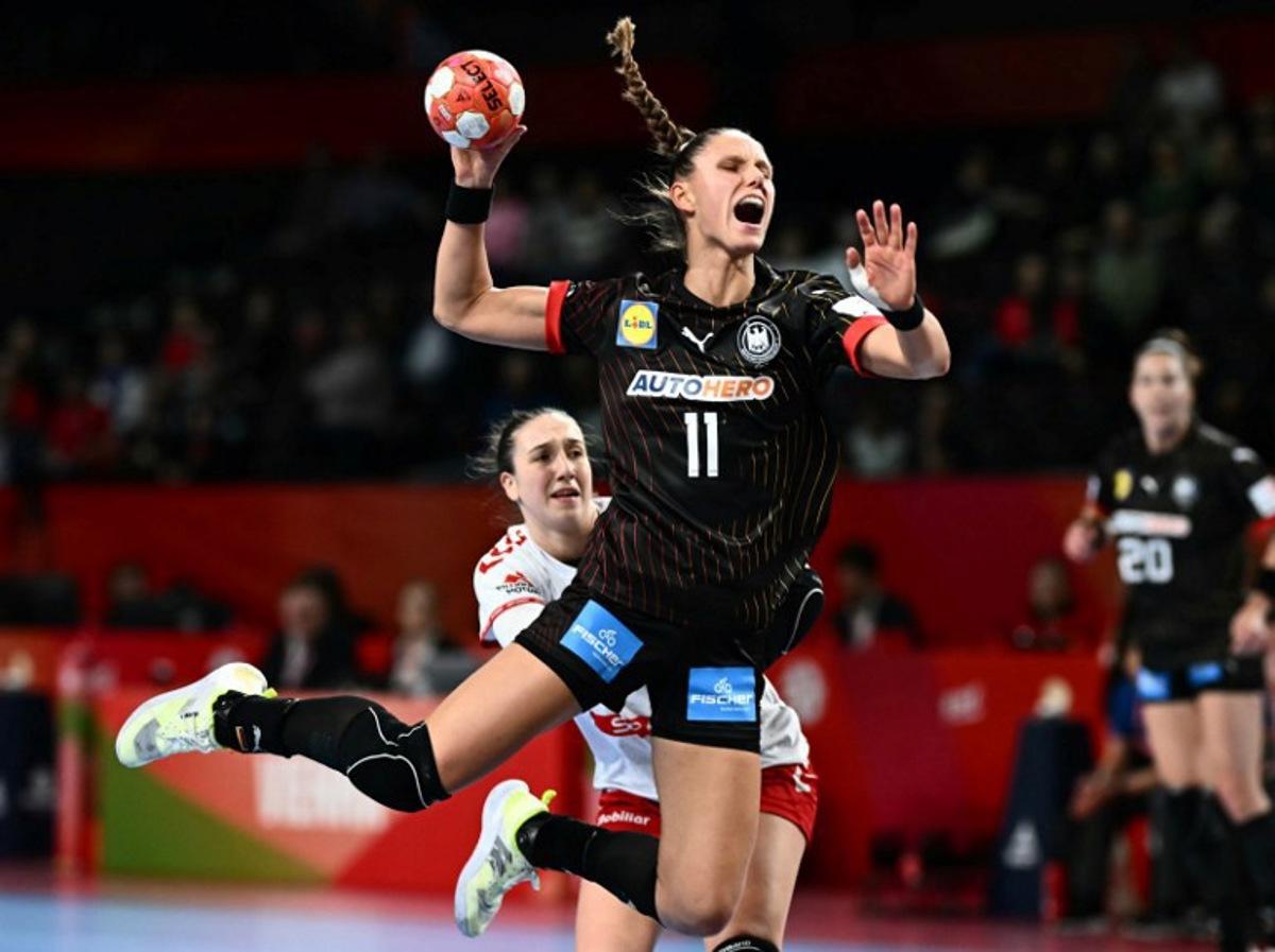 Germany's left back #11 Xenia Smits passes the ball during the European Women's EHF EURO 2024 Handball Championship Group II main round match between Switzerland and Germany in Vienna, Austria, on December 5, 2024.  Joe Klamar / AFP
