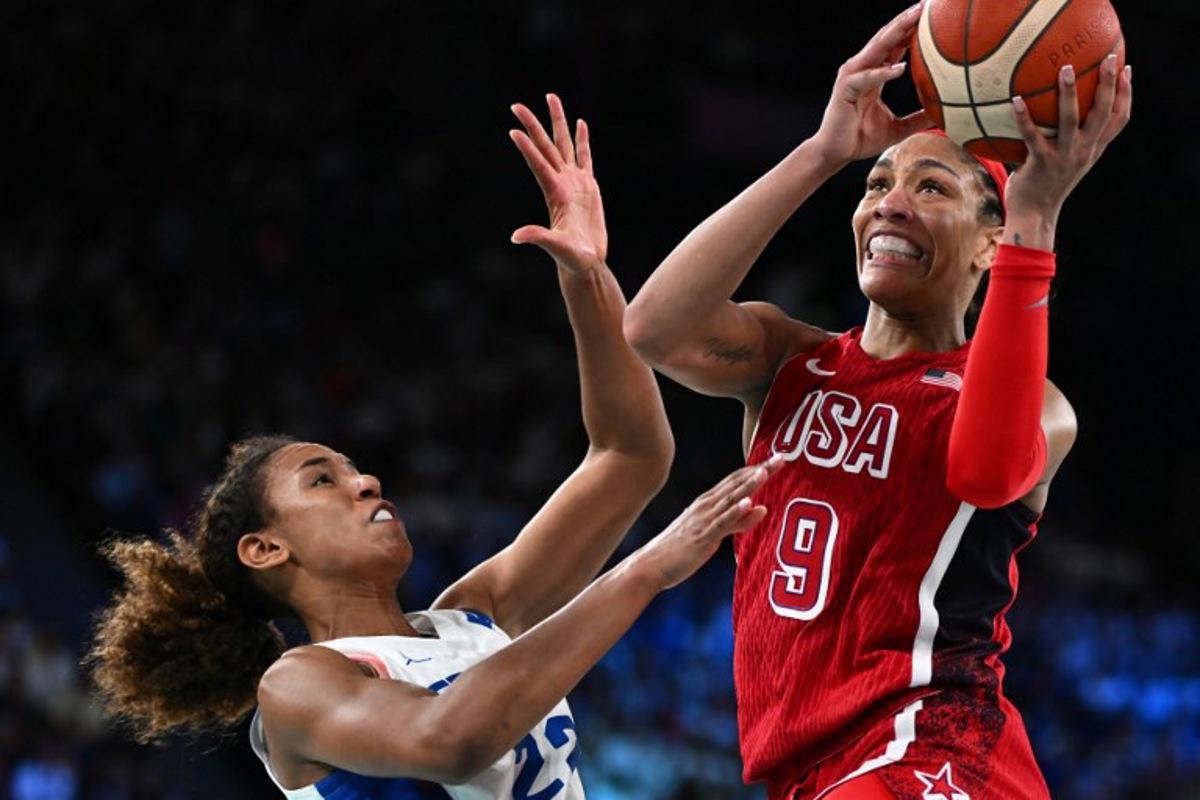 USA's #09 A'ja Wilson goes to the basket past France's #22 Marieme Badiane in the women's Gold Medal basketball match between France and the USA during the Paris 2024 Olympic Games at the Bercy  Arena in Paris on August 11, 2024.  Aris MESSINIS / AFP