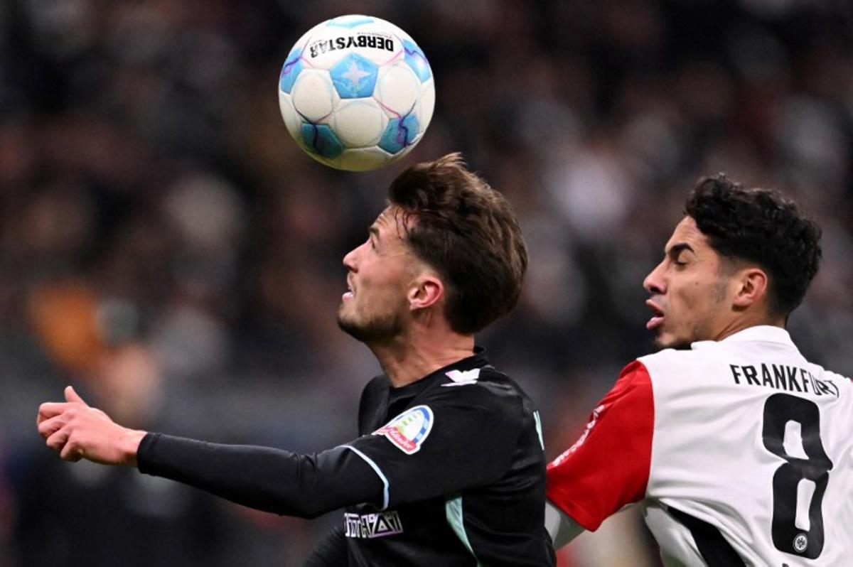 Bremen's Belgian midfielder #02 Olivier Deman (L) vies for the ball with Frankfurt's Algerian midfielder #08 Fares Chaibi during the German first division Bundesliga football match between Eintracht Frankfurt and Werder Bremen in Frankfurt am Main, western Germany on November 23, 2024.  Kirill KUDRYAVTSEV / AFP