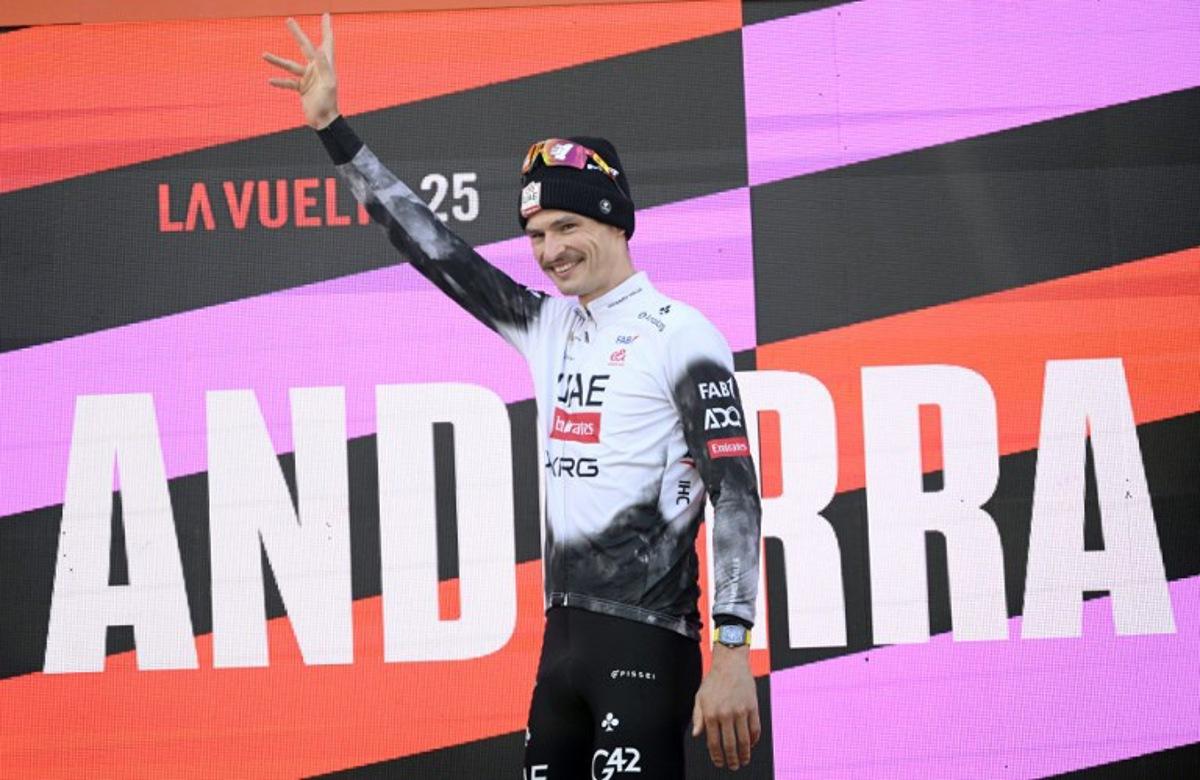 Team UAE's Australian rider Jay Vine celebrates on the podium after winning the sixth stage of La Vuelta a Espana cycling tour, a 170 km race between Olot and Pal, in Andorra, on August 28, 2025.    Josep LAGO / AFP