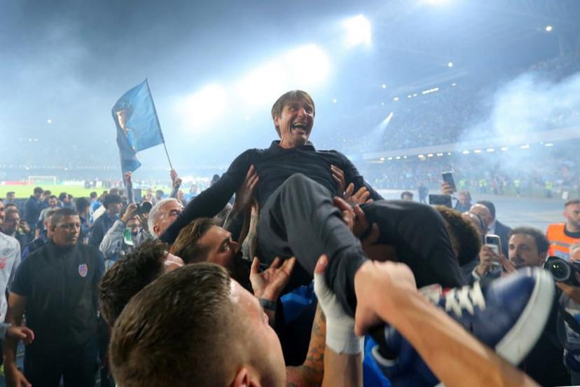 Napoli's Italian coach Antonio Conte is thrown in the air by his players as they celebrate after winning Italian Serie A football match between Napoli and Cagliari at the Diego Armando Maradona stadium in Naples on May 23, 2025.  Carlo Hermann / AFP