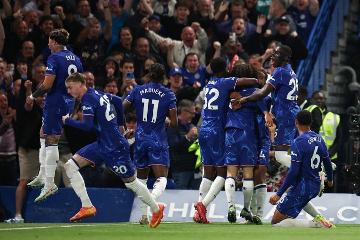 Chelsea's Spanish defender #03 Marc Cucurella (unseen) celebrates with teammates after scoring his team first goal during the English Premier League football match between Chelsea and Manchester United at Stamford Bridge in London on May 16, 2025.  HENRY NICHOLLS / AFP