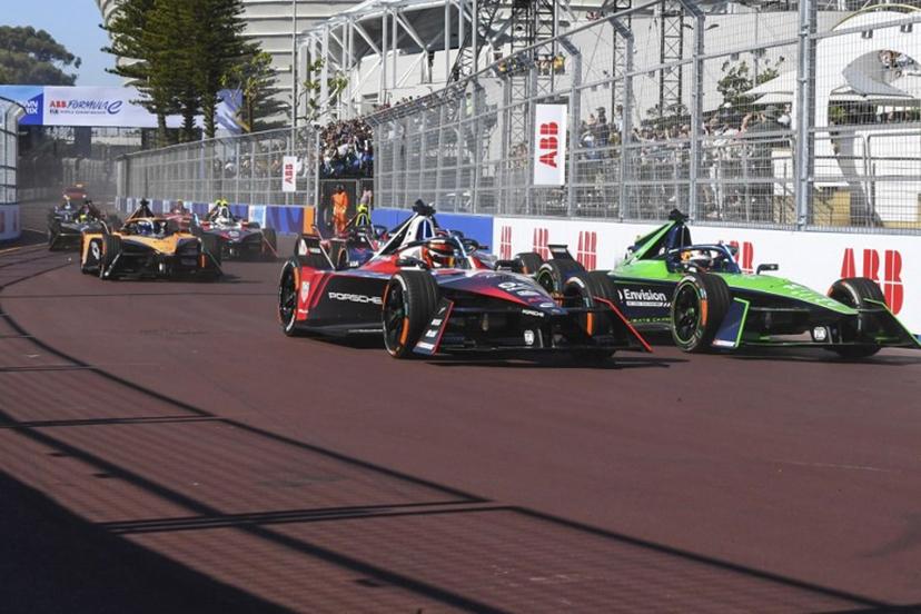 Tag Huer Porche's driver Pascal Wehrlein (L) and Envision Racing's driver Sebastien Buemi (R) drive during the 2023 Cape Town E-Prix in Cape town on February 25, 2023.  Rodger Bosch / AFP