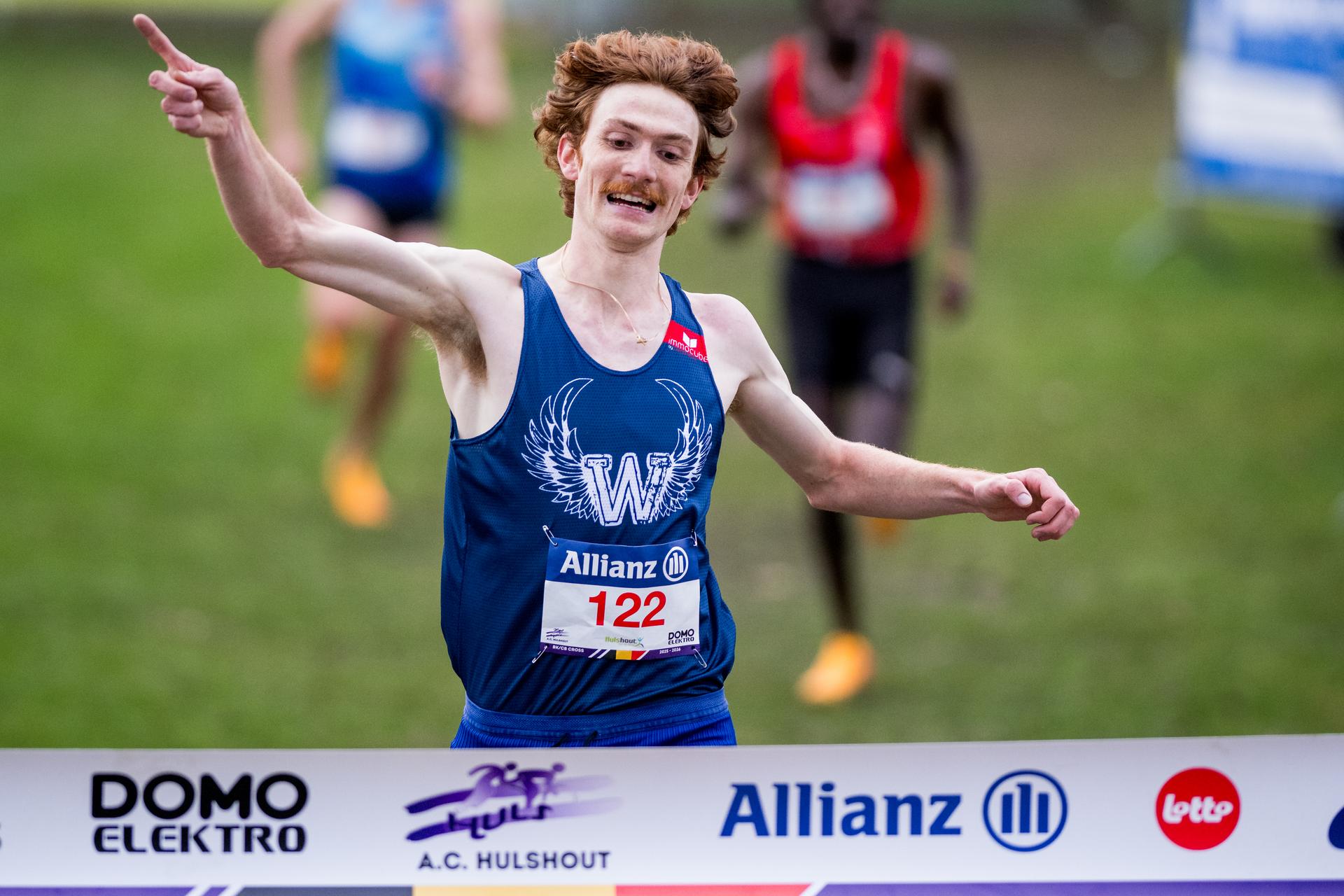 Ruben Querinjean celebrates as he crosses the finish line to win the men's race at the Belgian championships cross country running, in Hulshout, Sunday 30 November 2025. BELGA PHOTO JASPER JACOBS