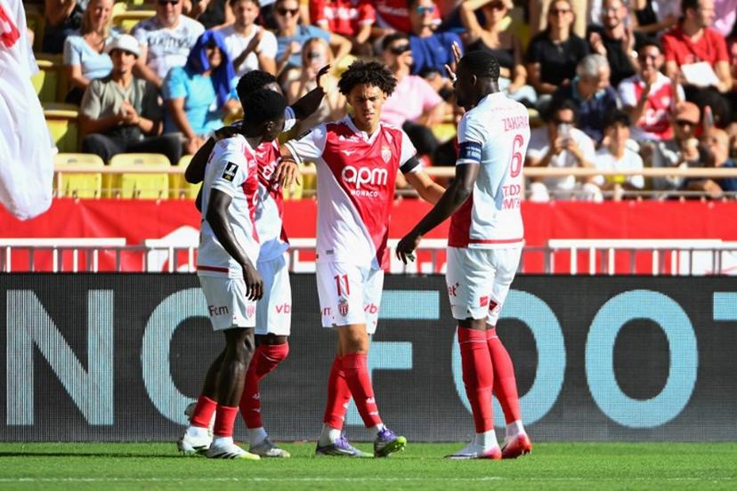 Monaco's French midfielder #11 Maghnes Akliouche (C) celebrates scoring his team's first goal during the French L1 football match between AS Monaco and RC Strasbourg Alsace at the Louis II Stadium in the Principality of Monaco on August 31, 2025.  FREDERIC DIDES / AFP
