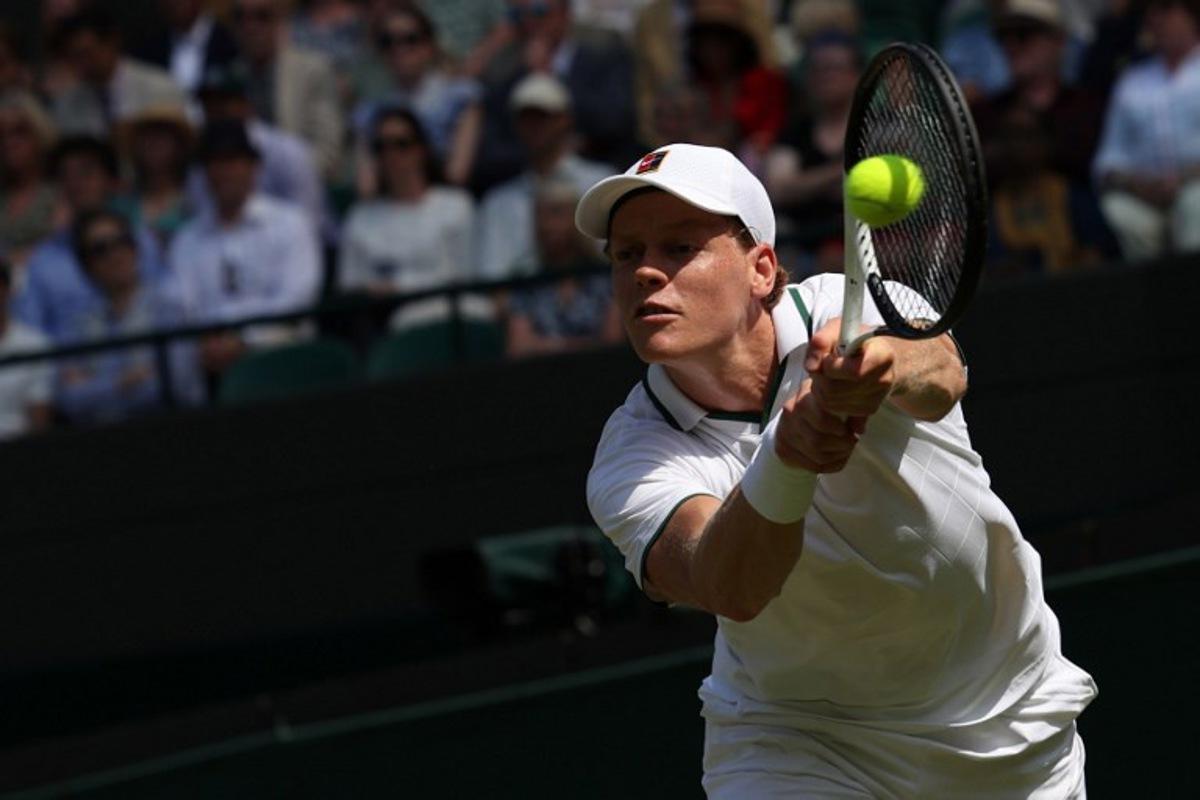 Italy's Jannik Sinner returns to US player Jenson Brooksby during their men's singles third round tennis match on the fifth day of the 2026 Wimbledon Championships at The All England Lawn Tennis and Croquet Club in Wimbledon, southwest London, on July 3, 2026.  Adrian Dennis / AFP