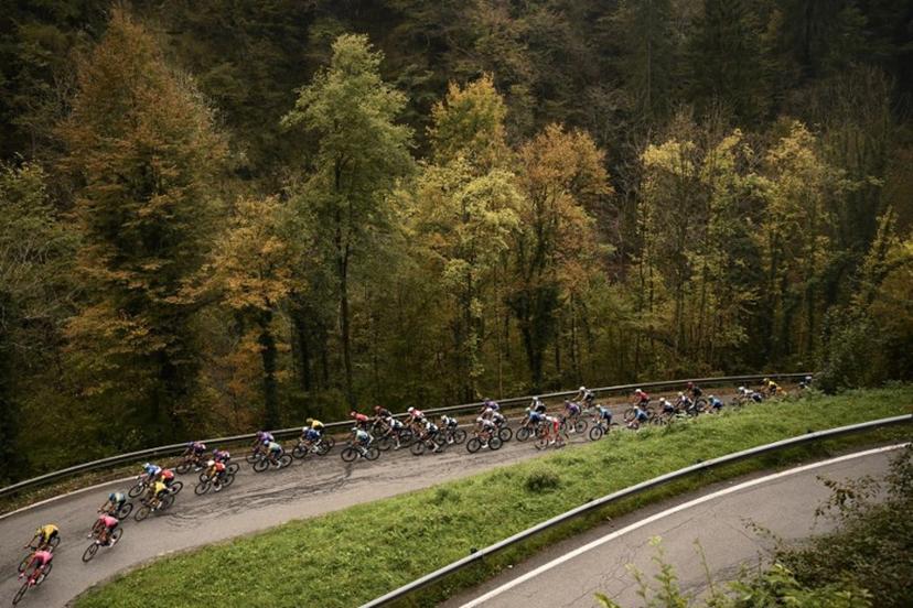 The pack of riders (peloton) cycles in the Passo Della Crocetta ascent during the 119th edition of the Giro di Lombardia (Tour of Lombardy), a 238km cycling race from Como to Bergamo on October 11, 2025.  Marco BERTORELLO / AFP