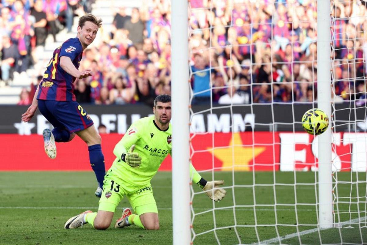 Barcelona's Dutch midfielder #21 Frenkie De Jong scores his team's second goal during the Spanish league football match between FC Barcelona and Levante UD at Camp Nou Stadium in Barcelona on February 22, 2026.  Josep LAGO / AFP
