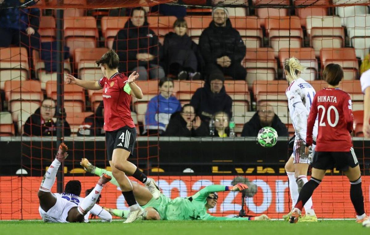 Lyon's Malawi forward #22 Tabitha Chawinga (L) scores the opening goal during the UEFA Women's Champions League, league phase football match between Manchester United and OL Lyonnes at the Progress With Unity Stadium in Leigh, western Manchester, on December 10, 2025.  Darren Staples / AFP
