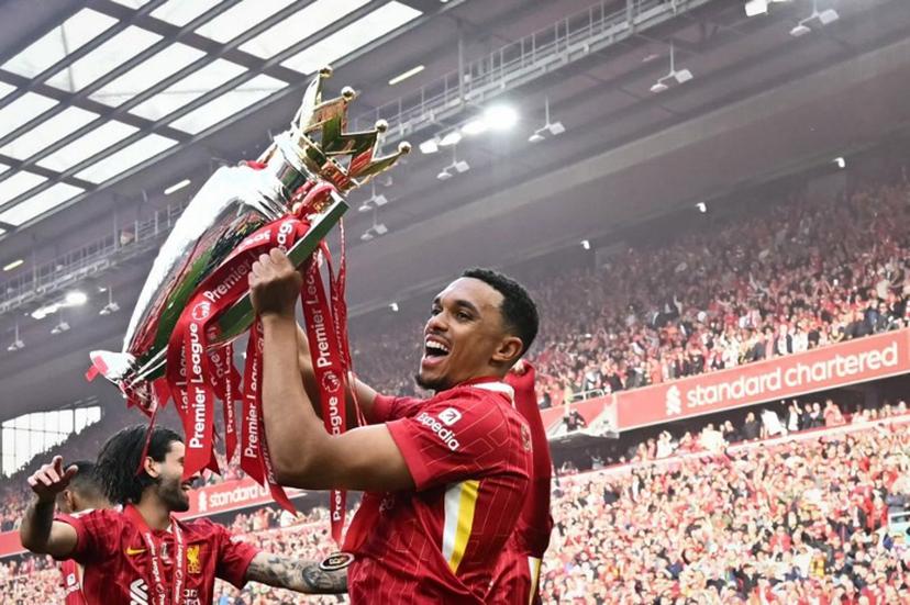 Liverpool's English defender #66 Trent Alexander-Arnold celebrates with the Premier League trophy at the end of the English Premier League football match between Liverpool and Crystal Palace at Anfield in Liverpool, north west England on May 25, 2025. Liverpool equalises 1 - 1 against Crystal Palace. Paul ELLIS / AFP