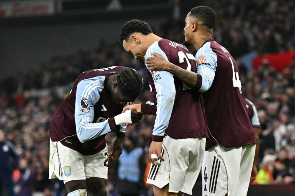 Aston Villa's English midfielder #27 Morgan Rogers (C) celebrates scoring his team's first goal to take the lead 1-0 during the English Premier League football match between Aston Villa and Manchester United at Villa Park in Birmingham, central England on December 21, 2025.  Ben STANSALL / AFP