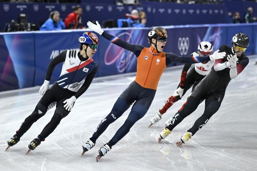 Netherlands' Jens van 't Wout (C) celebrates as he crosses the finish line to win gold in the short track speed skating men's 1500m final during the Milano Cortina 2026 Winter Olympic Games at Milano Ice Skating Arena in Milan on February 14, 2026.  WANG Zhao / AFP