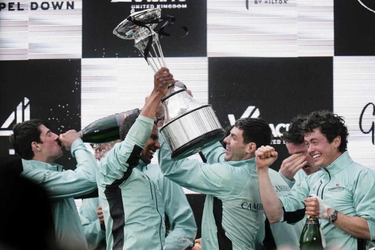 Cambridge's French president, Noam Mouelle celebrates lifts the trophy after winning the 171th men's boat race between Oxford University and Cambridge University on the River Thames in London on April 4, 2026.    CARLOS JASSO / AFP