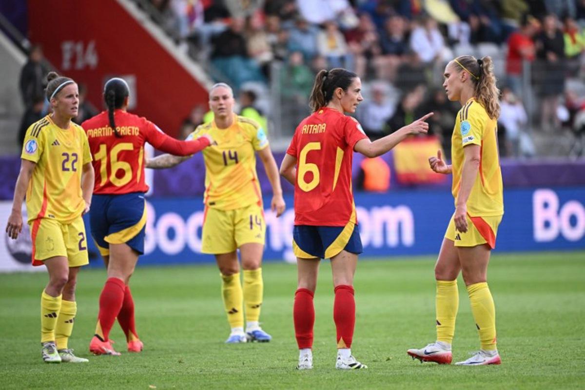Spain's midfielder #06 Aitana Bonmati (2nd R) and Belgium's defender #11 Janice Cayman (R) react after Spain won the  UEFA Women's Euro 2025 Group B football match between Spain and Belgium at the Arena Thun stadium in Thun on July 7, 2025.  SEBASTIEN BOZON / AFP