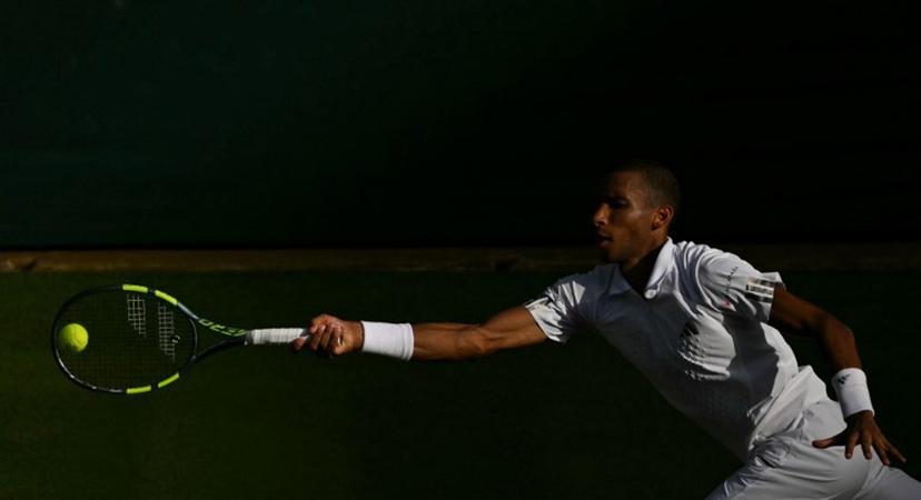 Canada's Felix Auger-Aliassime returns to Spain's Alejandro Davidovich Fokina during their men's singles round of 16 tennis match on the seventh day of the 2026 Wimbledon Championships at The All England Lawn Tennis and Croquet Club in Wimbledon, southwest London, on July 5, 2026.  Glyn KIRK / AFP