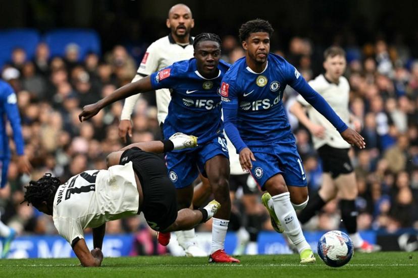 Port Vale's English midfielder #12 Rhys Walters is fouled by Chelsea's Belgian midfielder #45 Romeo Lavia and  Chelsea's Brazilian midfielder #17 Andrey Santos (R) during the English FA Cup quarter final football match between Chelsea and Port Vale at Stamford Bridge in London on April 4, 2026.  Ben STANSALL / AFP