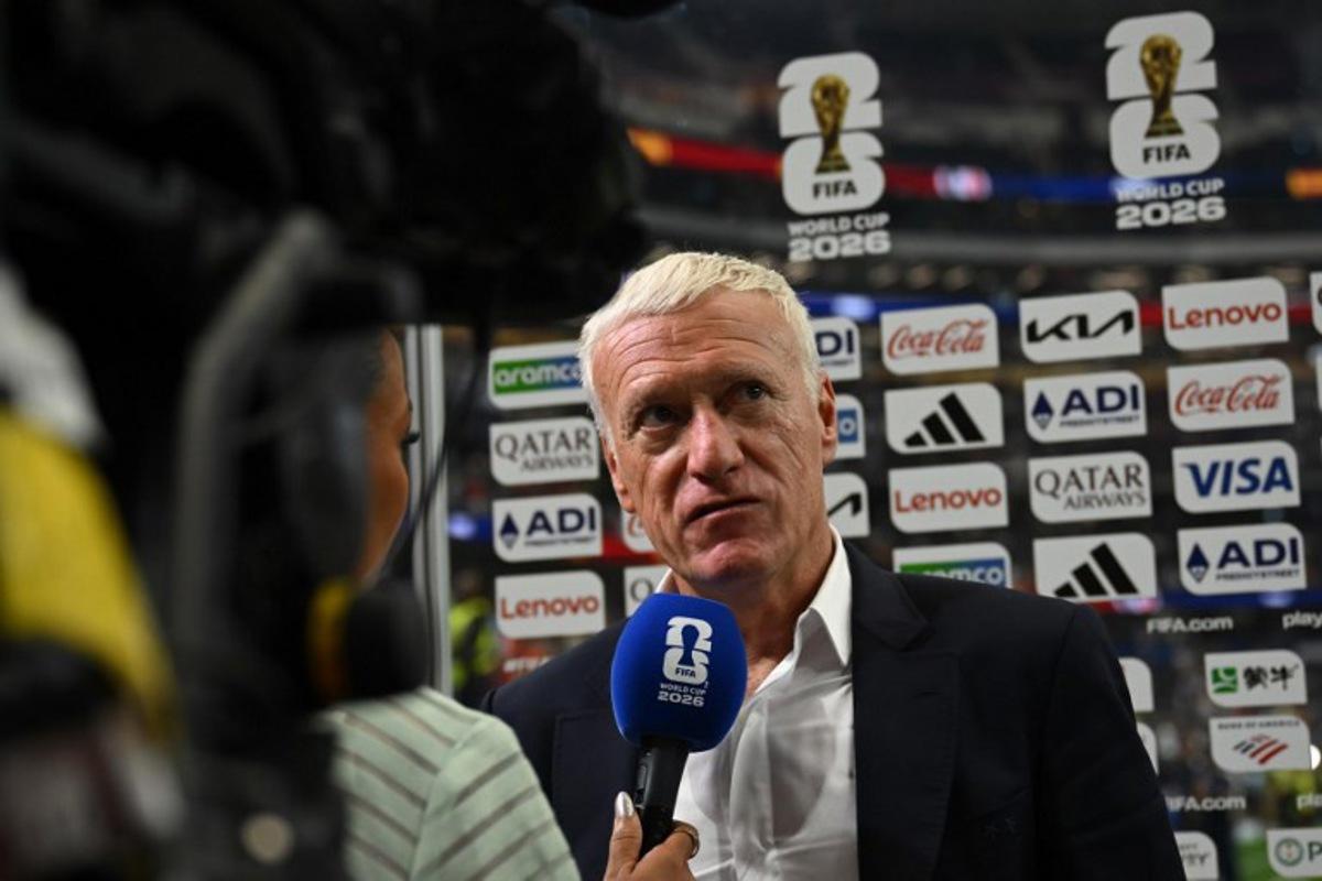 France's head coach Didier Deschamps speaks with a sports broadcaster after his team lost the 2026 World Cup football tournament semi-final match between France and Spain at the Dallas Stadium in Arlington on July 14, 2026.   Paul ELLIS / AFP