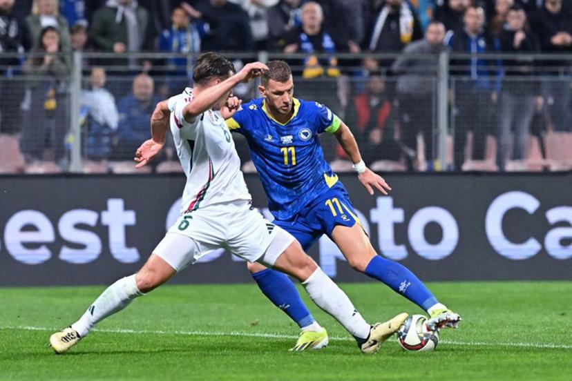 Bosnia and Herzegovina's forward #11 Edin Dzeko (R) fights for the ball with Hungary's defender #06 Willi Orban during the UEFA Nations League, League A - Group 3, football match between Bosnia and Herzegovina and Hungary at the Bilino Polje Stadium in Zenica, in Zenica, on October 14, 2024.  Elvis Barukcic / AFP