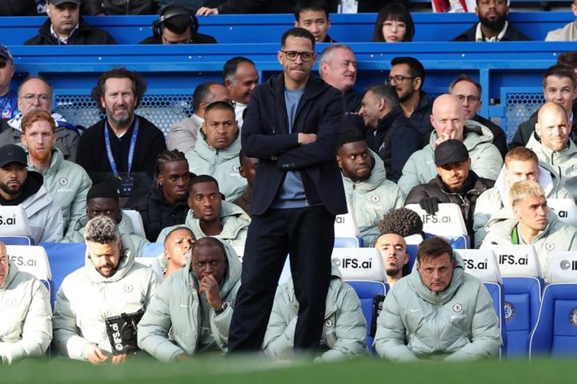 Chelsea's English head coach Liam Rosenior watches his team during the English Premier League football match between Chelsea and Manchester City at Stamford Bridge in London on April 12, 2026.  Adrian Dennis / AFP