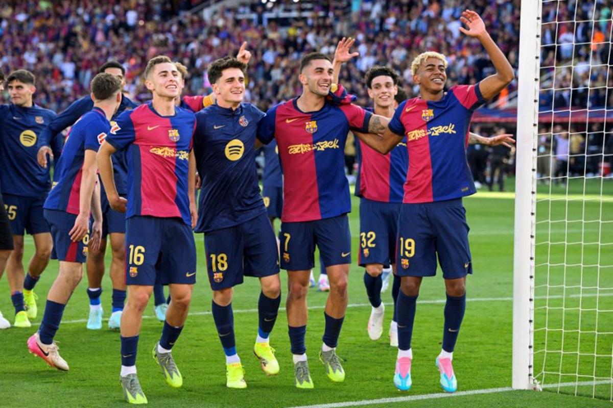 Barcelona's players celebrate victory at the end of the Spanish league football match between FC Barcelona and Real Madrid CF at Estadi Olimpic Lluis Companys in Barcelona, on May 11, 2025. Barcelona won 4-3. Josep LAGO / AFP