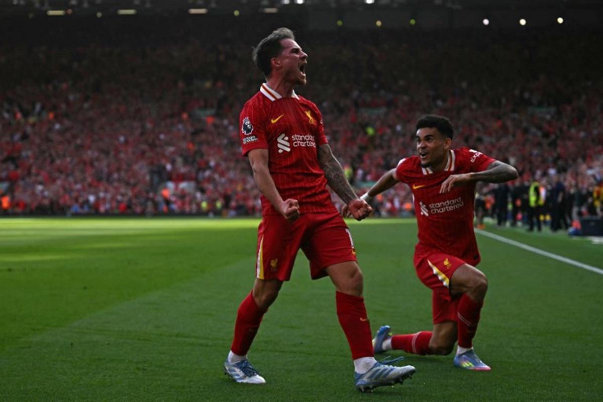 Liverpool's Argentinian midfielder #10 Alexis Mac Allister (L)  celebrates with Liverpool's Colombian midfielder #07 Luis Diaz (R) after scoring their second goal during the English Premier League football match between Liverpool and Tottenham Hotspur at Anfield in Liverpool, north west England on April 27, 2025.  Paul ELLIS / AFP