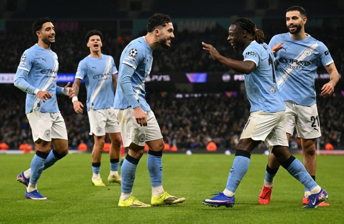 Manchester City's French midfielder #10 Rayan Cherki (C) celebrates scoring the team's second goal with Manchester City's Belgian midfielder #11 Jeremy Doku during the UEFA Champions League football match between Manchester City and Galatasaray at the Etihad Stadium in Manchester, north west England, on January 28, 2026.  Oli SCARFF / AFP