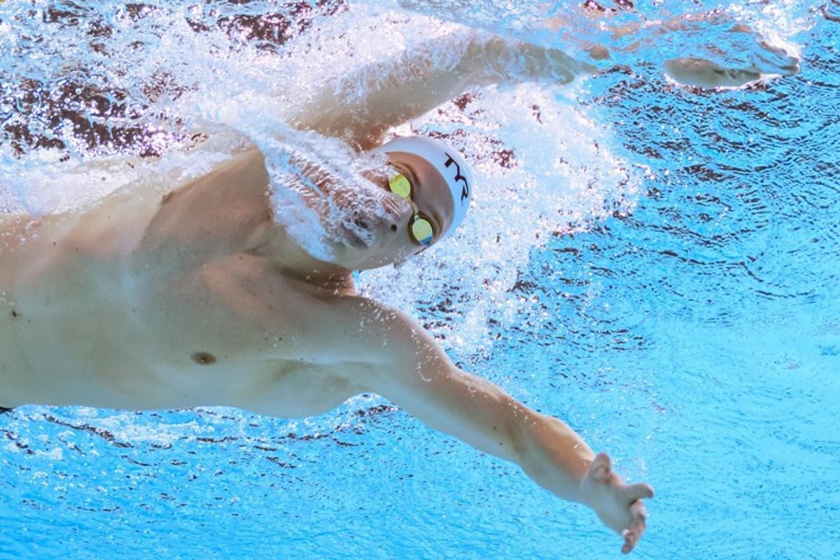 France's swimmer Leon Marchand competes in a heat of the men's 400m individual medley swimming event during the 2025 World Aquatics Championships in Singapore on August 3, 2025.  François-Xavier MARIT / AFP