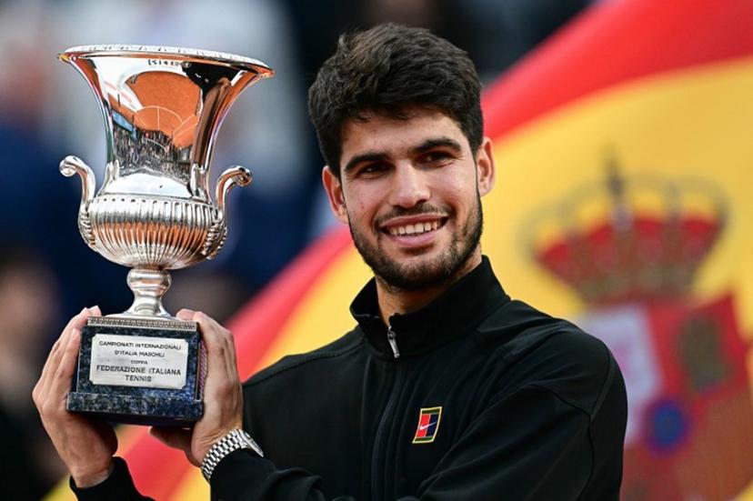 Spain's Carlos Alcaraz shows his winner trophy at the end of his men's singles final match against Italy's Jannik Sinner for the ATP Rome Open tennis tournament at Foro Italico in Rome on May 18, 2025.   Tiziana FABI / AFP